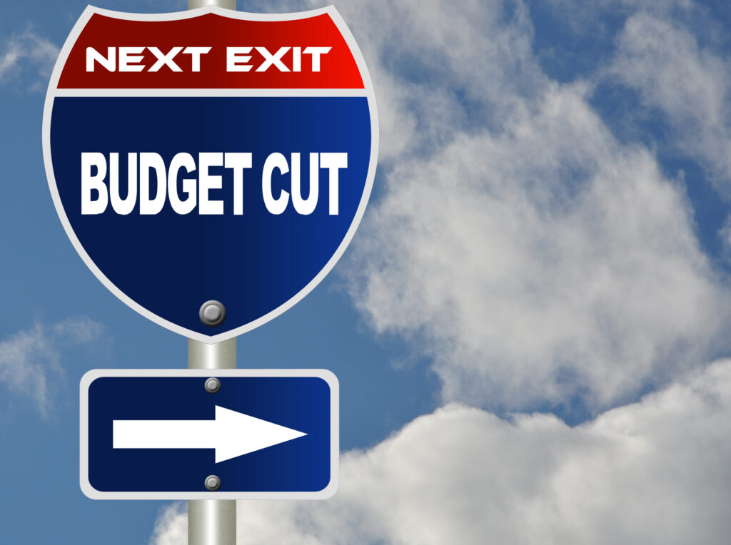 Budget cut road sign